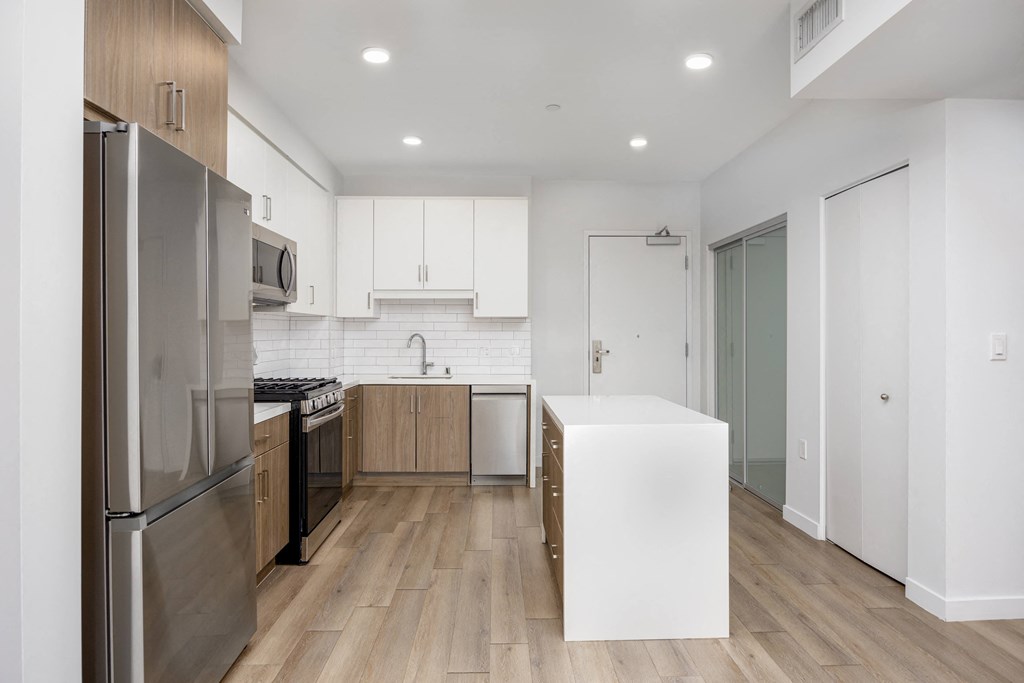kitchen with white cabinets and stainless steel appliances and center island