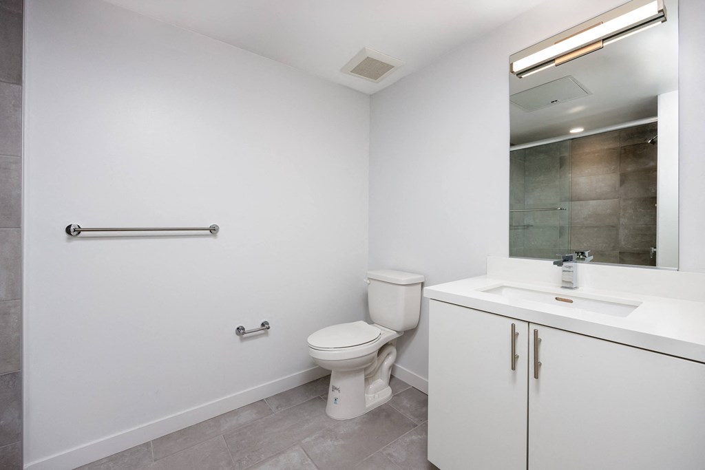 a white bathroom with a toilet and a sink