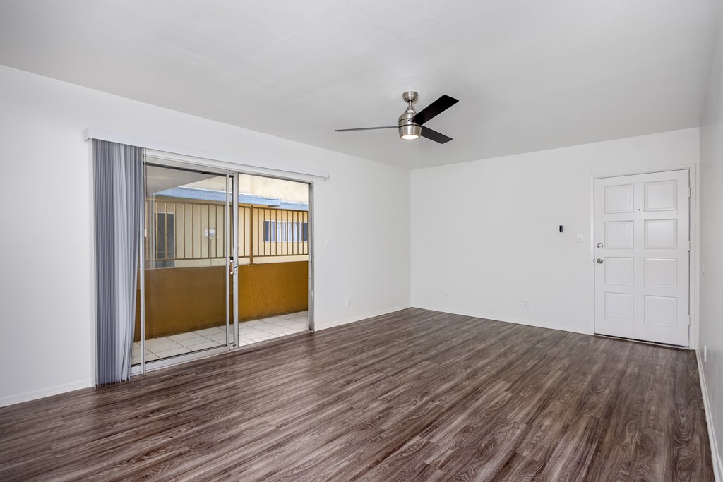 A room with a sliding door and a ceiling fan.