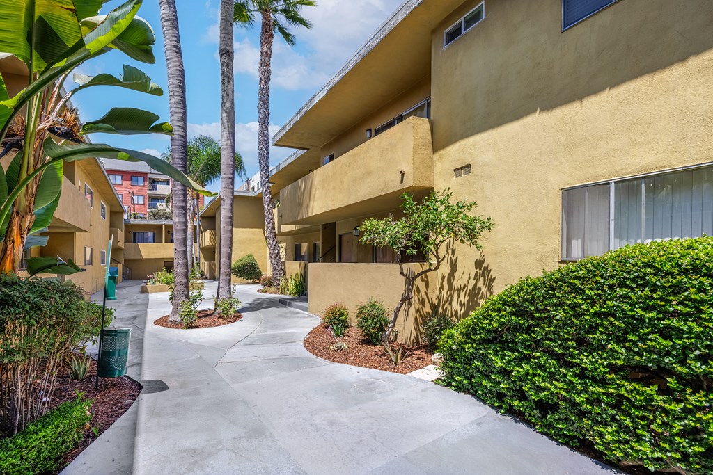A sunny day at the apartment complex with a clear blue sky.