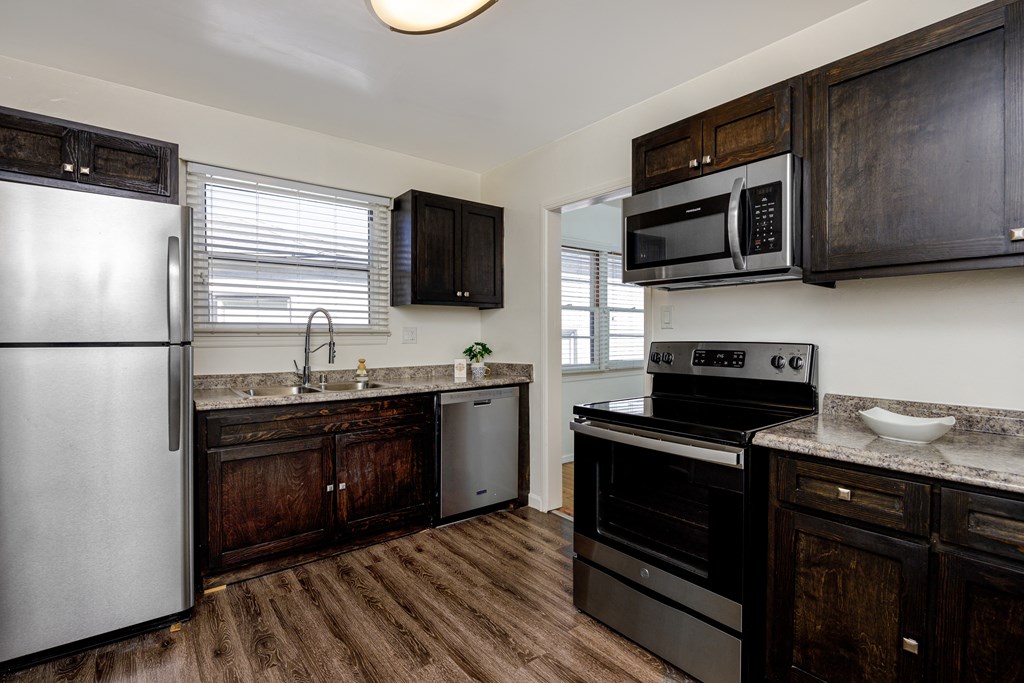 a kitchen with stainless steel appliances and wooden cabinets