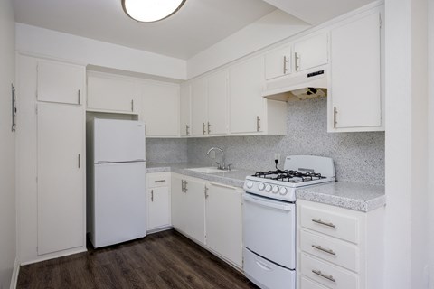 a kitchen with white appliances and white cabinets