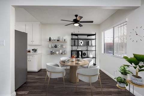 A modern kitchen with a dining table and chairs.