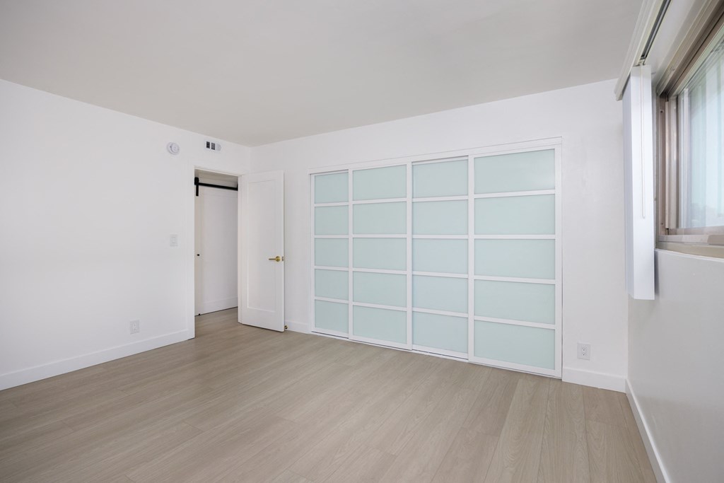 an empty room with a large white wall and a door