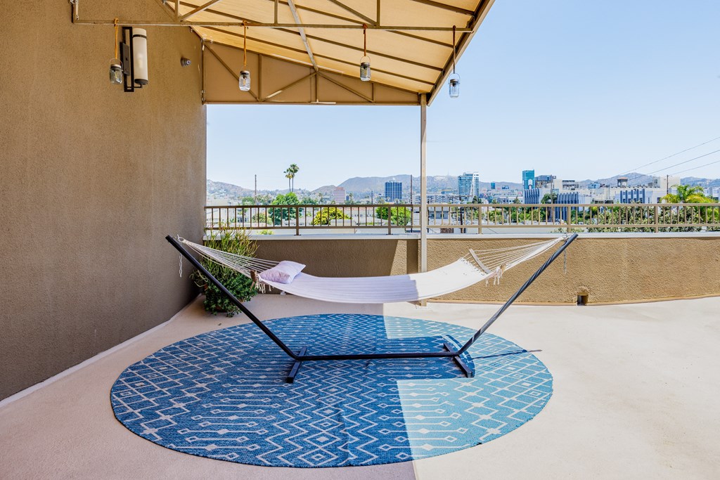 a hammock on a balcony with a view of the city