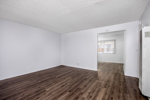 Empty room with wooden floor and white walls.