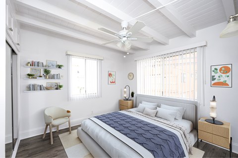 A bedroom with a bed, chair, and ceiling fan.