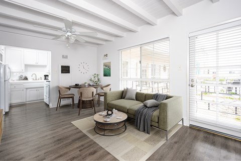 A living room with a couch, chairs, and a table.