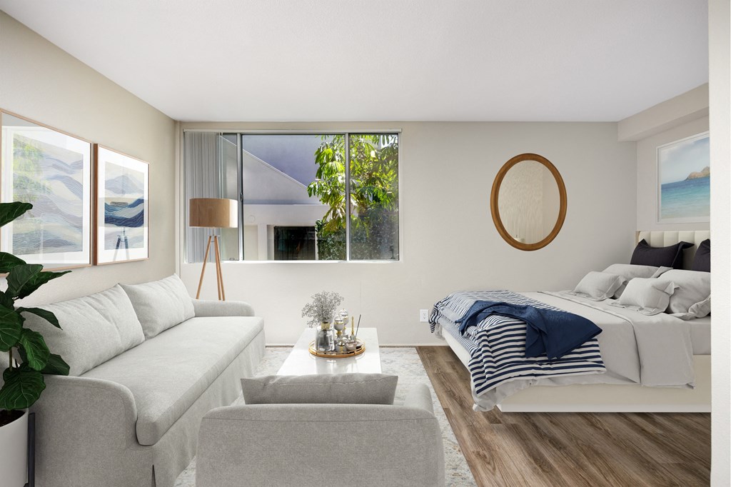 a bedroom with a couch and a bed and a window