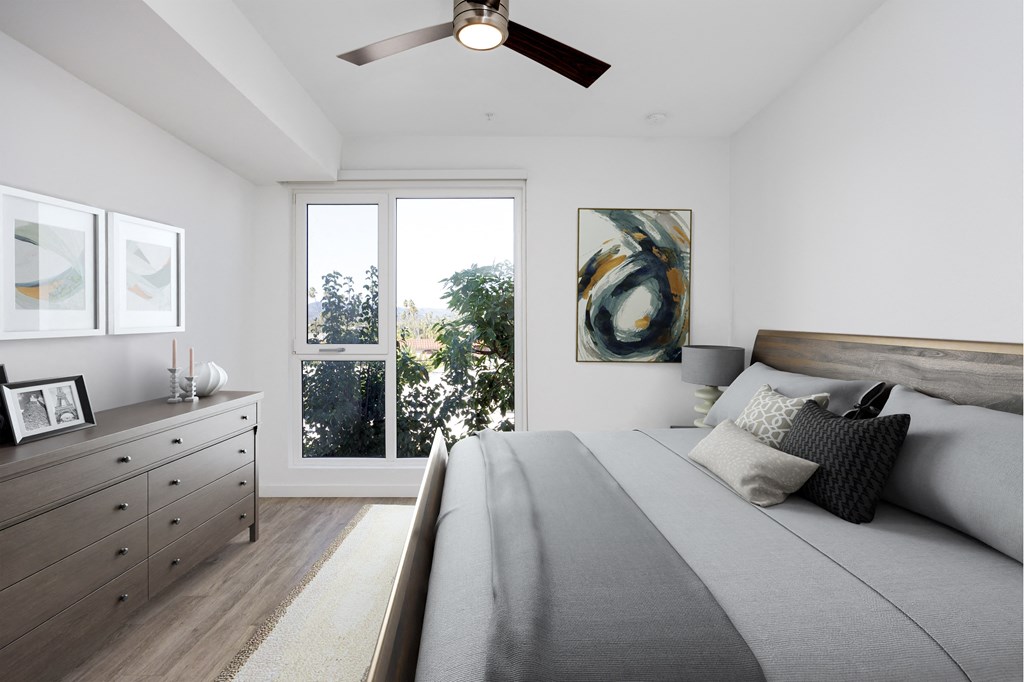 a bedroom with a large bed and a ceiling fan