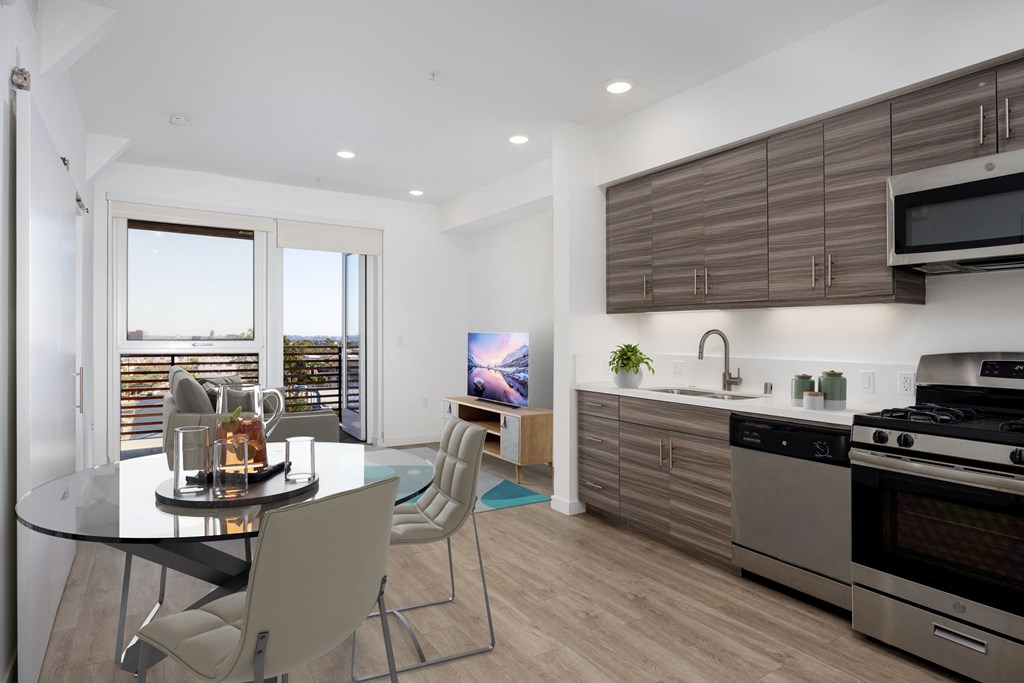 a kitchen and dining room with a glass table and chairs