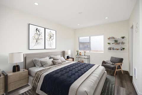 A bedroom with a large bed and a chair.
