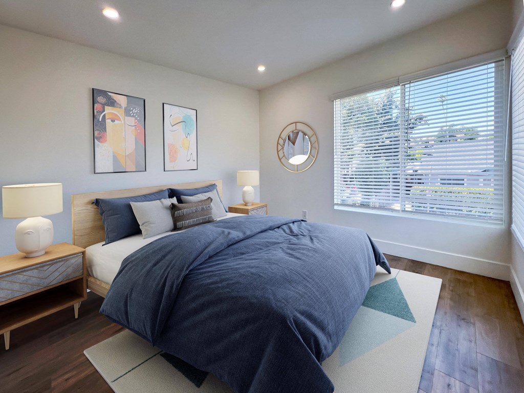 a bedroom with a bed and a large window