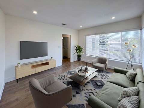 a living room with a couch and chairs and a television