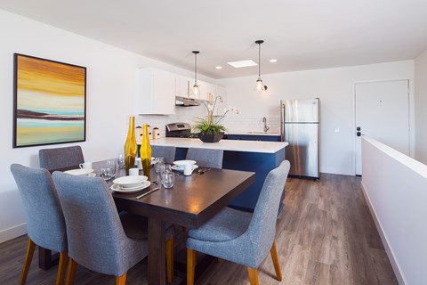 A dining room with a table set for four.