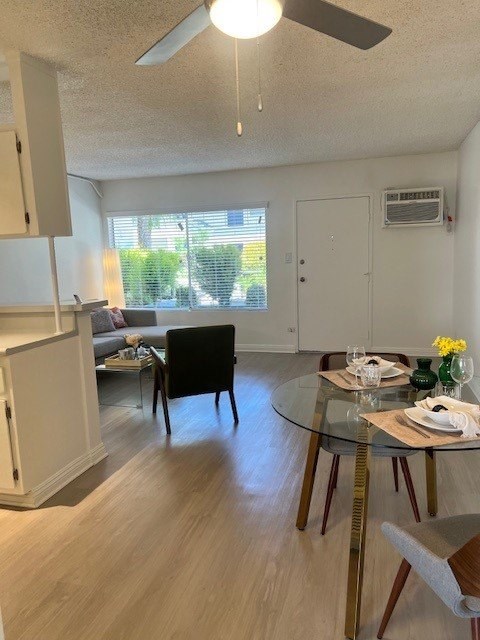 A dining room with a glass table and chairs.