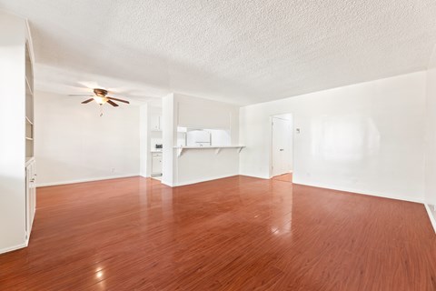 A room with wooden floors and a ceiling fan.