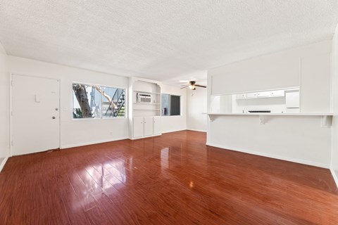 A room with wooden floors and white walls.