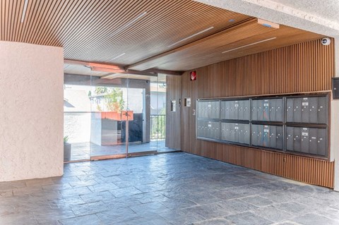 a large lobby with a row of lockers and a glass door