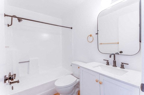 a bathroom with a sink toilet and a bath tub