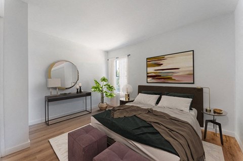 a bedroom with a bed and a mirror on the wall