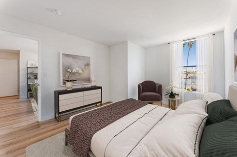 a bedroom with a bed and a living room