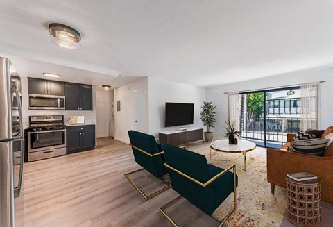 a living room with a kitchen and a sliding glass door