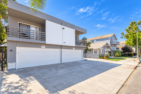 A modern two-story house with a white garage door.