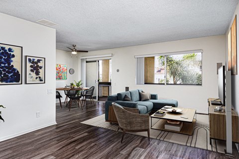 A living room with a couch, chairs, and a coffee table.