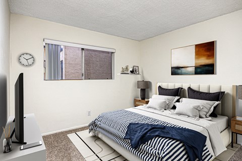 A bedroom with a bed, nightstand, and television.