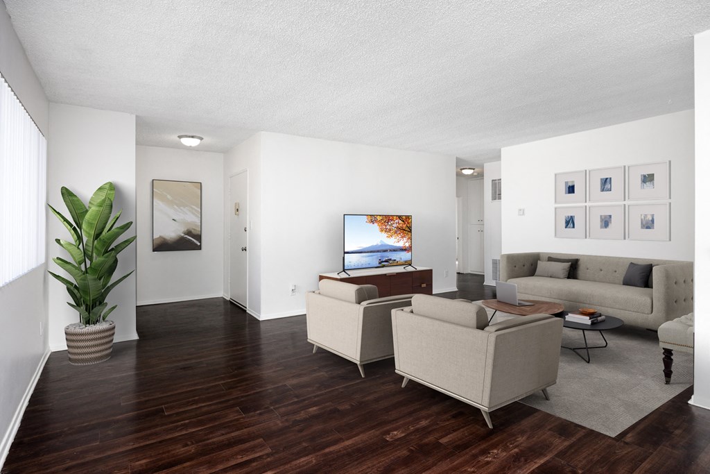 a living room with couches and chairs and a tv