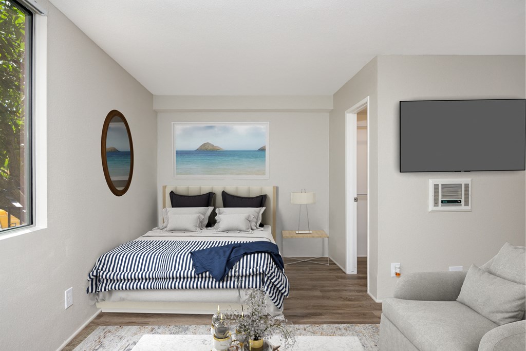 a bedroom with a bed and a tv on the wall