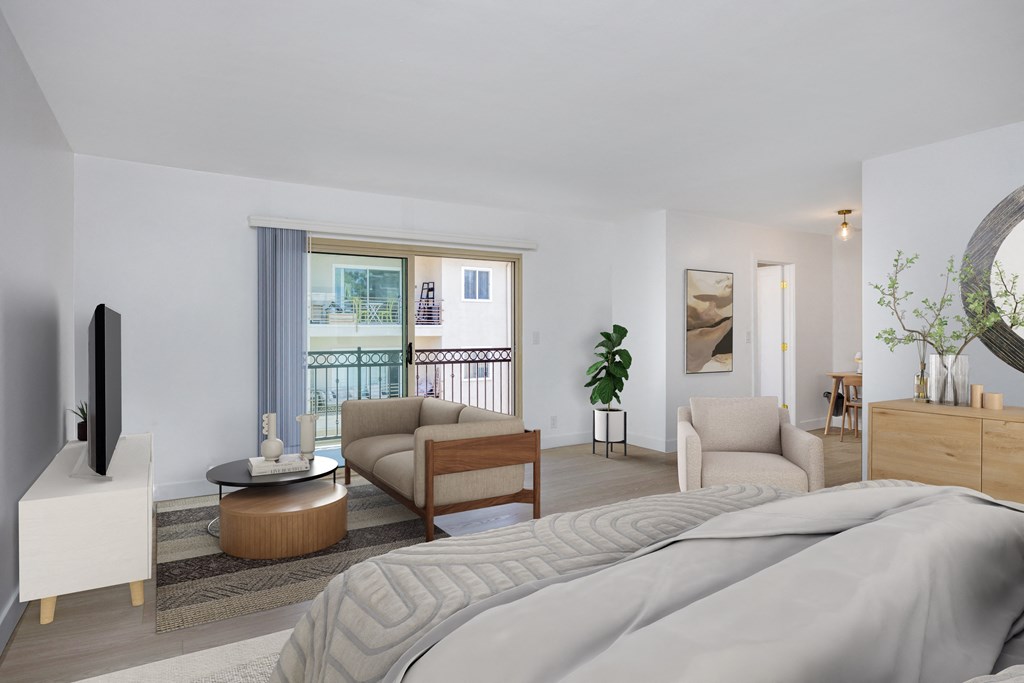 a bedroom with a bed and a living room with a balcony