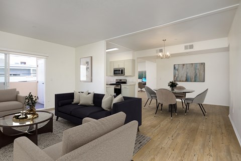 a living room and dining room with couches and chairs and a table with chairs