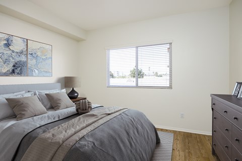 a bedroom with a large bed and a window