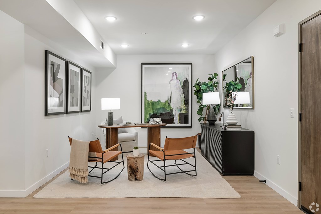 A modern living room with a wooden floor and white walls.