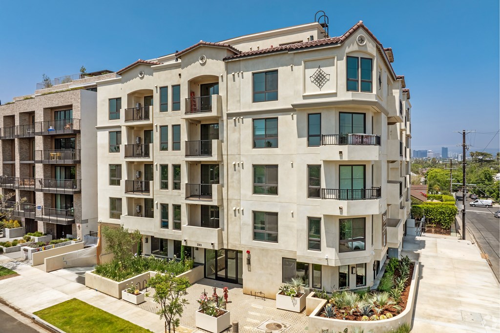 A large apartment building with balconies and multiple windows.