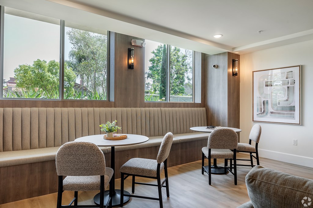 A dining room with a table and chairs.