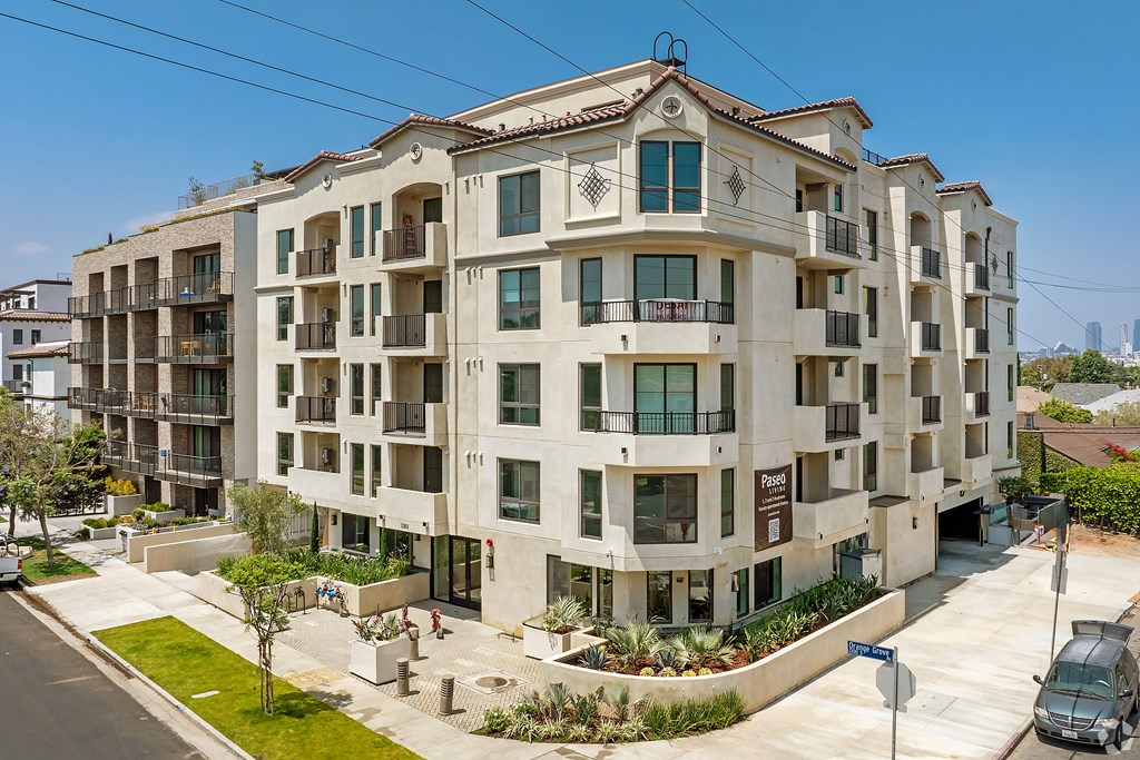 A large apartment building with a balcony on the second floor.