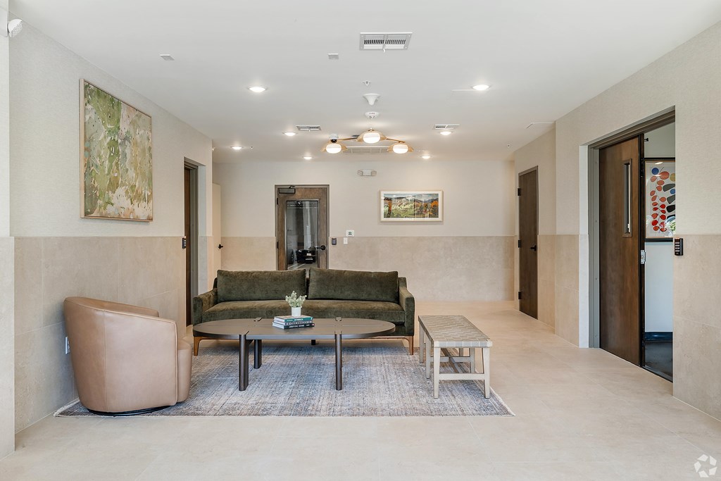 A living room with a couch, chair, and coffee table.