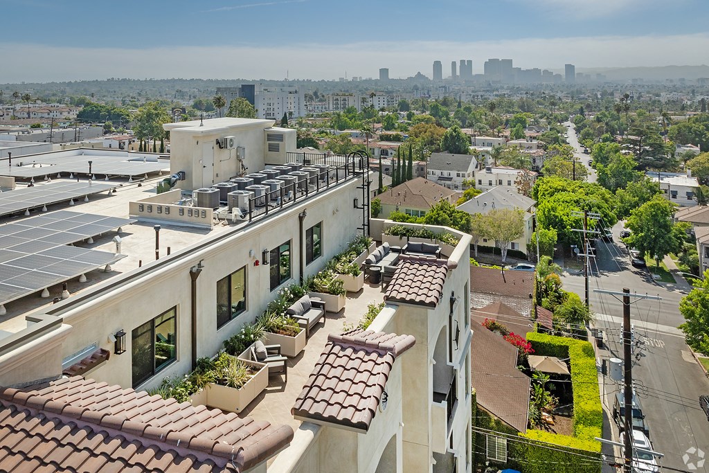 A view of a city from a high angle with buildings and a clear sky.