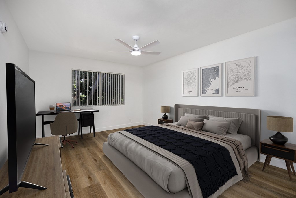 a bedroom with a bed and a desk and a ceiling fan
