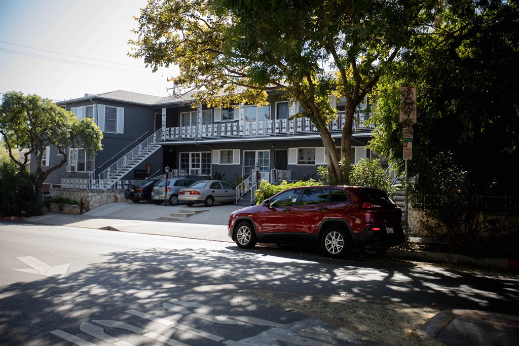 a red car parked in front of a house