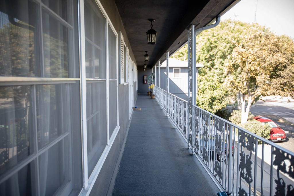 a porch with a long length of windows on the side of a building