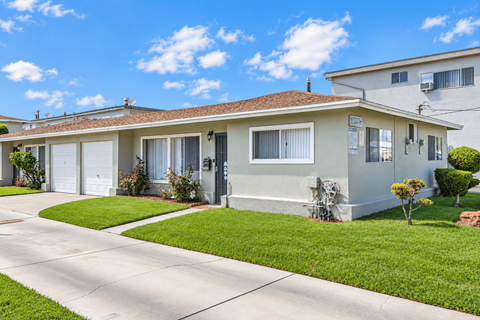 A house with a white garage door and a brown roof.