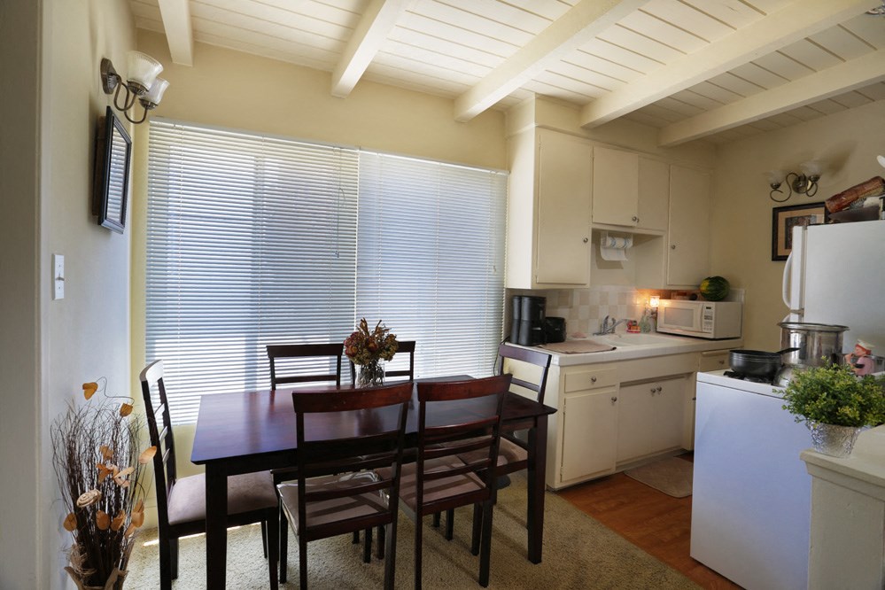 a kitchen and dining room with a table and chairs