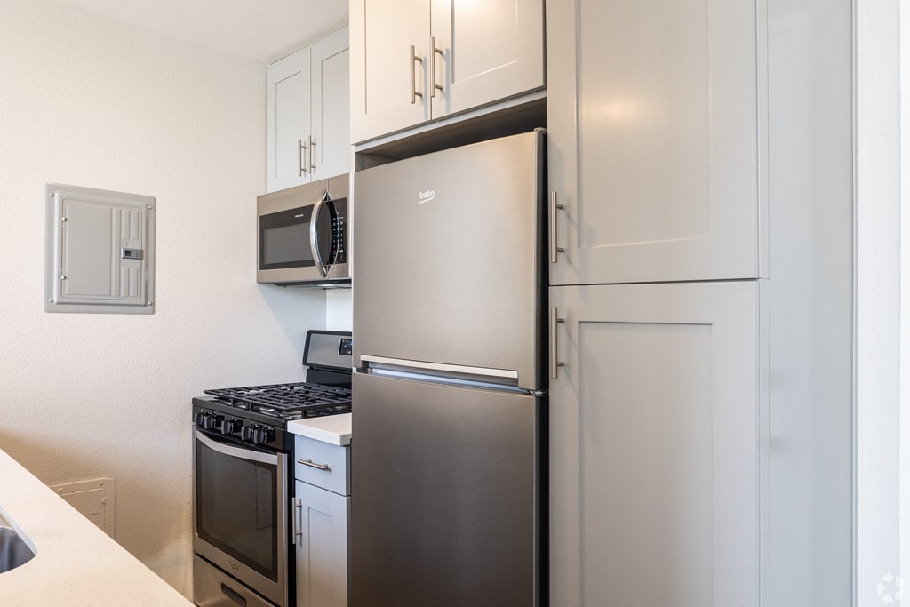 a kitchen with stainless steel appliances and a refrigerator