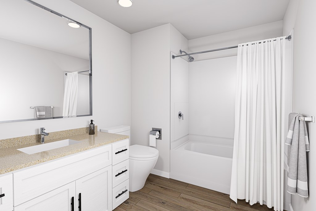 A white bathroom with a sink, toilet, and bathtub.