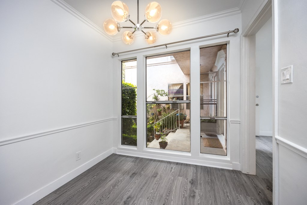 a bedroom with a large window and a chandelier
