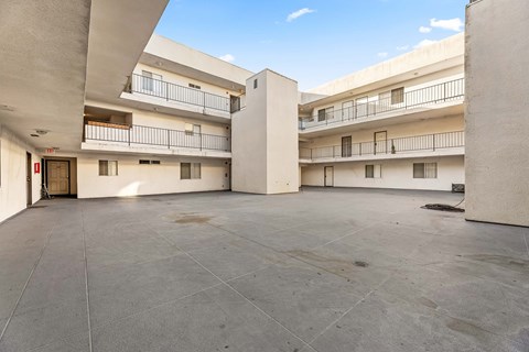 A large open courtyard with a building in the background.